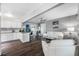 Open concept living room features modern white furniture, sleek flooring, and a seamless transition to the kitchen area at 8444 8Th N Way, St Petersburg, FL 33702