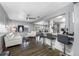 Bright and spacious living room with a modern ceiling fan, stylish seating, and an open layout to the kitchen at 8444 8Th N Way, St Petersburg, FL 33702