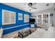 Bright living room with a blue accent wall, tile flooring, modern furniture, and outdoor access at 8444 8Th N Way, St Petersburg, FL 33702