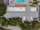 Aerial view of the Timber Oaks clubhouse, pool, and surrounding greenery offering a serene setting at 8531 Woodcrest Dr, Port Richey, FL 34668