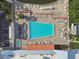Overhead aerial view of the community pool, surrounded by lounge chairs and well-kept grounds at 8531 Woodcrest Dr, Port Richey, FL 34668