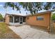 Spacious backyard featuring a screened lanai and concrete tile, perfect for outdoor entertaining at 8531 Woodcrest Dr, Port Richey, FL 34668
