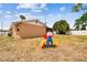 Spacious backyard with room to play and a view of the screened patio at 8531 Woodcrest Dr, Port Richey, FL 34668