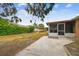 Expansive backyard with a screened-in patio, lush greenery, and play set at 8531 Woodcrest Dr, Port Richey, FL 34668