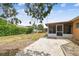 Expansive backyard with a screened-in patio, lush greenery, and play set at 8531 Woodcrest Dr, Port Richey, FL 34668