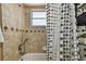 Bright bathroom featuring a shower-tub and neutral tile at 8531 Woodcrest Dr, Port Richey, FL 34668