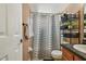 Bathroom with neutral walls, shower and tub combination and wood cabinet vanity at 8531 Woodcrest Dr, Port Richey, FL 34668