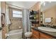 Bathroom with shower and tub combination and wood cabinet vanity at 8531 Woodcrest Dr, Port Richey, FL 34668