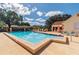 Community pool surrounded by sun loungers, perfect for relaxation and recreation at 8531 Woodcrest Dr, Port Richey, FL 34668