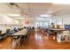 Bright craft room with tables, chairs, storage, and sewing machines at 8531 Woodcrest Dr, Port Richey, FL 34668
