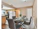 Cozy dining room with a glass table set for a meal, adjacent to the kitchen at 8531 Woodcrest Dr, Port Richey, FL 34668
