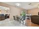 Dining area features a glass table set, connecting to the kitchen and office space at 8531 Woodcrest Dr, Port Richey, FL 34668