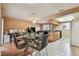 Dining room with glass table and four chairs with kitchen view at 8531 Woodcrest Dr, Port Richey, FL 34668
