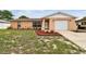 Charming single-story home featuring a well-manicured lawn and an attached one-car garage at 8531 Woodcrest Dr, Port Richey, FL 34668