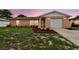 Charming single-story home featuring a well-manicured lawn and an attached one-car garage at 8531 Woodcrest Dr, Port Richey, FL 34668