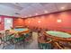 Well-lit game room with tables and chairs, perfect for social gatherings at 8531 Woodcrest Dr, Port Richey, FL 34668