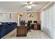 Home office with neutral wall colors and ceiling fan at 8531 Woodcrest Dr, Port Richey, FL 34668