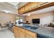 Open kitchen featuring wood cabinets, granite countertops and stainless steel sink at 8531 Woodcrest Dr, Port Richey, FL 34668