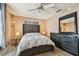 Comfortable bedroom includes soft carpet, dresser, and a ceiling fan at 8531 Woodcrest Dr, Port Richey, FL 34668