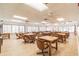 Large meeting room with tables, chairs and natural light from windows at 8531 Woodcrest Dr, Port Richey, FL 34668