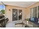 Cozy screened patio with a glass table and grill overlooking the backyard at 8531 Woodcrest Dr, Port Richey, FL 34668