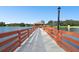 Picturesque waterfront pier with a gazebo, benches, and seating perfect for lakeside enjoyment at 8531 Woodcrest Dr, Port Richey, FL 34668