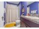Well-lit bathroom with shower, granite counters, and a decorative shower curtain at 9411 Lemon Drop Loop, Sun City Center, FL 33573