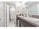 Bathroom featuring granite counters with dual vanity sinks and a shower/tub combo at 9411 Lemon Drop Loop, Sun City Center, FL 33573