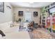Cozy bedroom with carpeted floors, a ceiling fan, and shelving for books and decorations at 9411 Lemon Drop Loop, Sun City Center, FL 33573