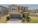 Charming two-story home with a well-maintained lawn, beautiful landscaping, and a two-car garage at 9411 Lemon Drop Loop, Sun City Center, FL 33573