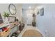 Bright foyer with a decorative mirror, console table, and coat rack, creating a welcoming entrance at 9411 Lemon Drop Loop, Sun City Center, FL 33573