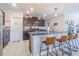 Stylish kitchen with granite countertops, dark cabinetry, stainless steel appliances, and a pantry at 9411 Lemon Drop Loop, Sun City Center, FL 33573