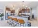 Modern kitchen featuring granite countertops, stainless steel appliances, and a breakfast bar with seating at 9411 Lemon Drop Loop, Sun City Center, FL 33573