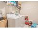 Well-equipped laundry room with modern washer and dryer, plus convenient shelving for storage at 9411 Lemon Drop Loop, Sun City Center, FL 33573
