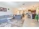 Open-concept living room connected to the kitchen, featuring a large sectional sofa and stylish decor at 9411 Lemon Drop Loop, Sun City Center, FL 33573