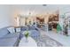Open-concept living room and kitchen featuring stainless steel appliances and ample counter space at 9411 Lemon Drop Loop, Sun City Center, FL 33573