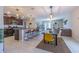 Open-concept living space featuring a kitchen with a breakfast bar and a cozy living room at 9411 Lemon Drop Loop, Sun City Center, FL 33573