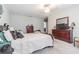 Spacious main bedroom with carpeted floors featuring a large bed and classic wooden dressers at 9411 Lemon Drop Loop, Sun City Center, FL 33573