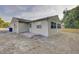Exterior of home with a patio and green space at 10319 Widgeon Way, New Port Richey, FL 34654