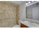 Clean bathroom features a tiled shower with safety bar and a sleek vanity at 10319 Widgeon Way, New Port Richey, FL 34654