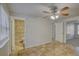 Large bedroom features tiled floors, ceiling fan and access to multiple rooms at 10319 Widgeon Way, New Port Richey, FL 34654