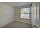 Small bedroom with neutral carpet and exterior view window at 10319 Widgeon Way, New Port Richey, FL 34654