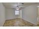 This bedroom features tile floors, a ceiling fan, and a window for natural light at 10319 Widgeon Way, New Port Richey, FL 34654