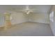 Bright, open living room features neutral carpet and ceiling fan at 10319 Widgeon Way, New Port Richey, FL 34654