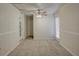 Cozy living room with wood-paneled walls, ceiling fan, and carpet at 10319 Widgeon Way, New Port Richey, FL 34654