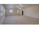 Large carpeted living area featuring a bright and airy atmosphere at 10319 Widgeon Way, New Port Richey, FL 34654