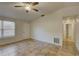 Cozy living room with tile flooring, a window, and a nearby hallway at 10319 Widgeon Way, New Port Richey, FL 34654