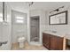 Bathroom featuring a toilet, shower, and vanity sink with a mirror at 10602 Camelia Dr, Port Richey, FL 34668