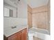 Bathroom featuring a vanity, toilet, and tiled shower/tub combo at 10602 Camelia Dr, Port Richey, FL 34668