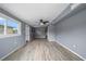This bedroom includes a ceiling fan, a window, and an exterior door at 10602 Camelia Dr, Port Richey, FL 34668